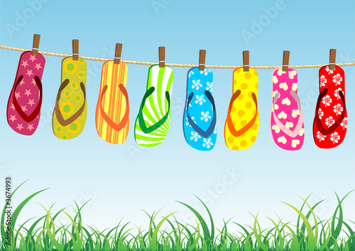 Beach sandals. Different colorful flip-flops hanged on a rope.