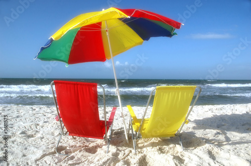 Beach scene with beach chairs and unbrella.