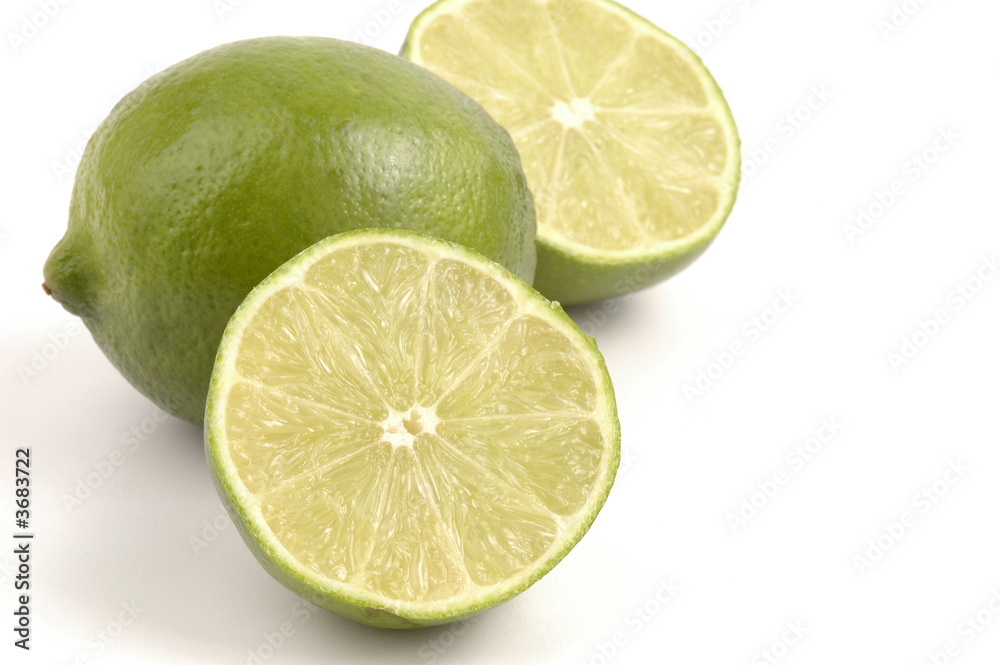Fresh green limes isolated on a white background. Fresh green limes isolated on a white background.
