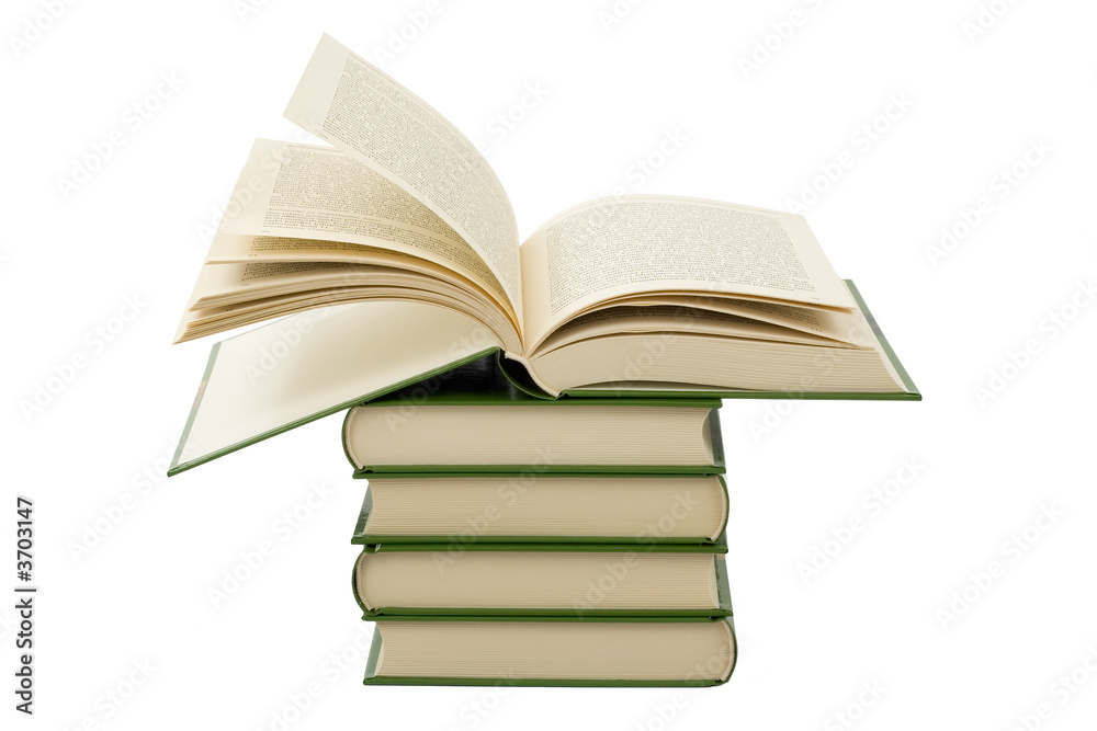 Open book lying on stack of books Open book lying on stack of books