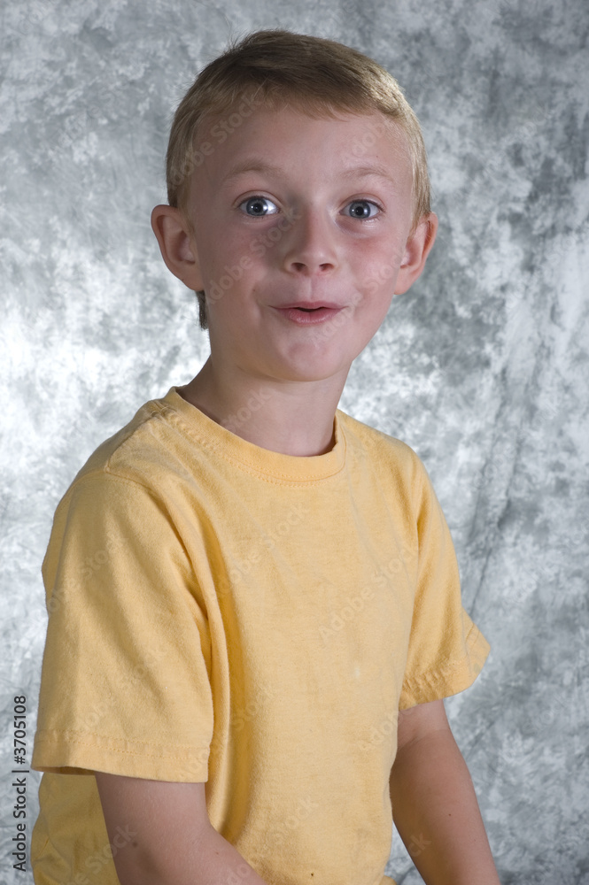 Young boy posing in front of photo backdrop