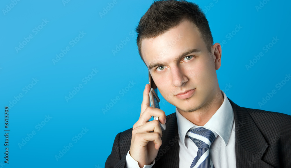 Attractive young businessman in black suit with mobile phone. Attractive young businessman in black suit with mobile phone.