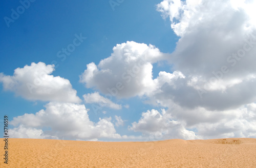 cloudy sky with sand in foreground