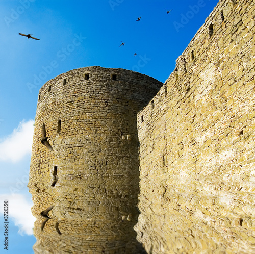 The flooded fortress on background sky and water. photo