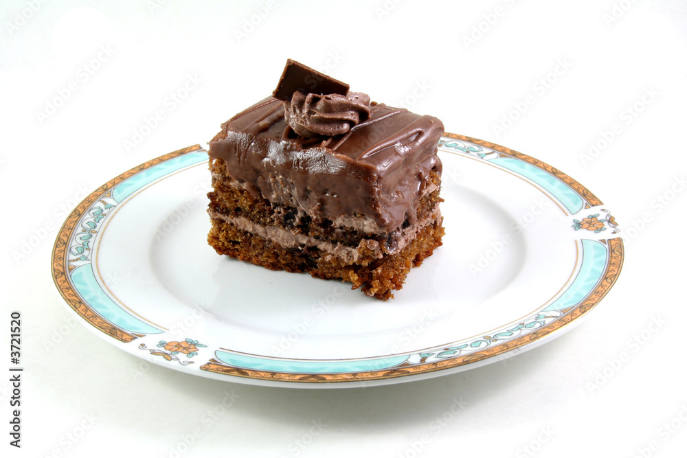slice of chocolate cake on a lukury plate isolated on white slice of chocolate cake on a lukury plate isolated on white