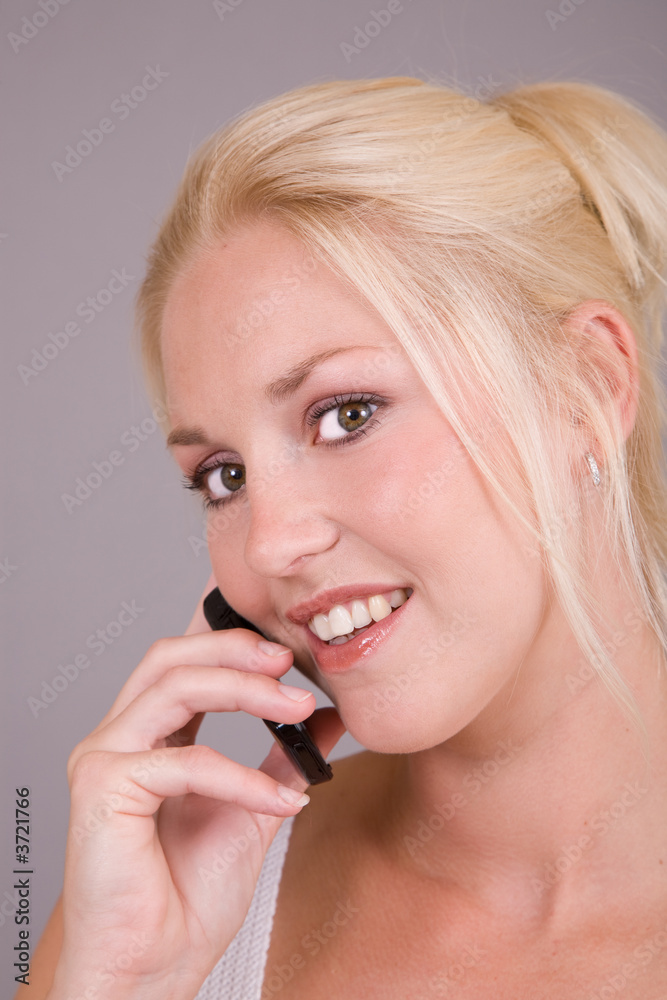Beautiful blond woman with a mobile phone in her hand Beautiful blond woman with a mobile phone in her hand