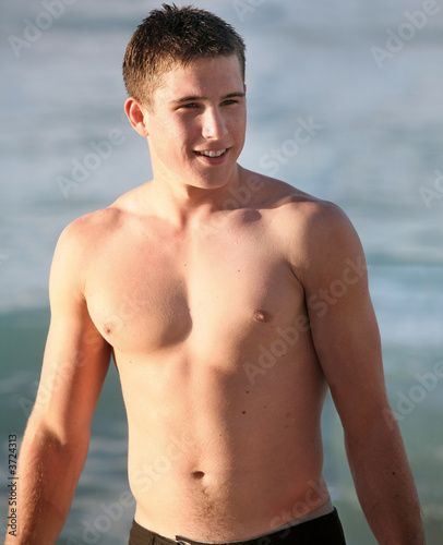 Happy young man getting out of the water