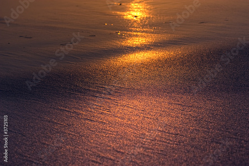 golden rays of sunlight on sand