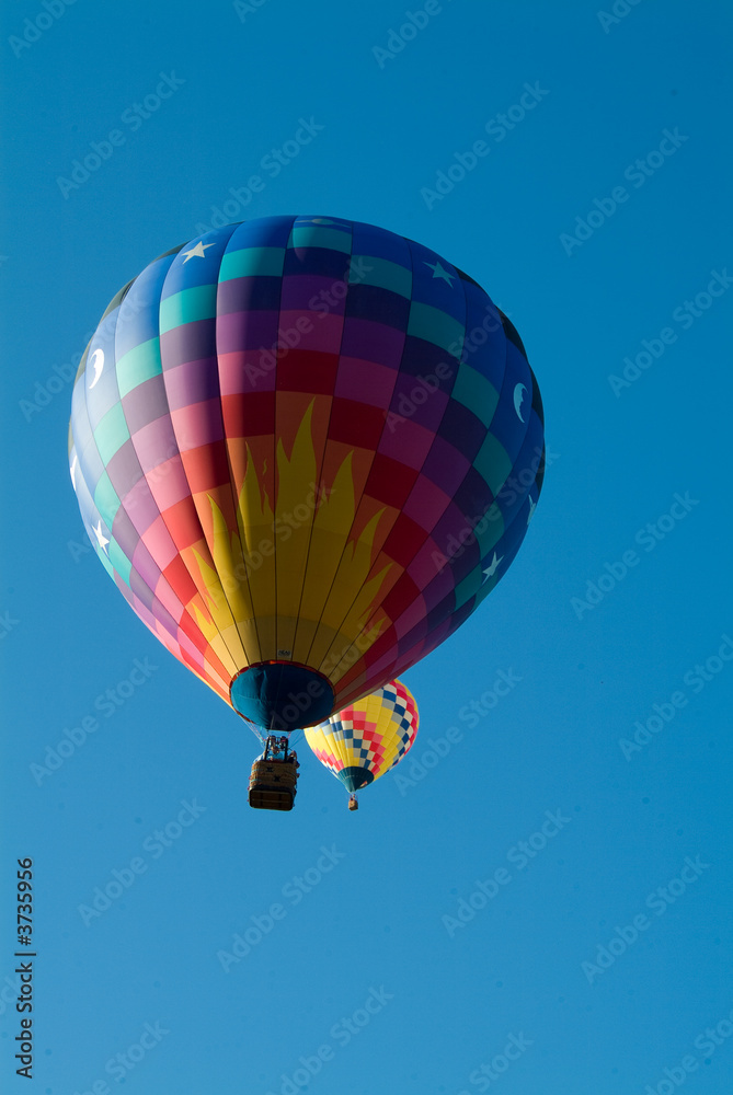 Two Hot Air Balloons rising into a clear Vermont Sky Two Hot Air Balloons rising into a clear Vermont Sky