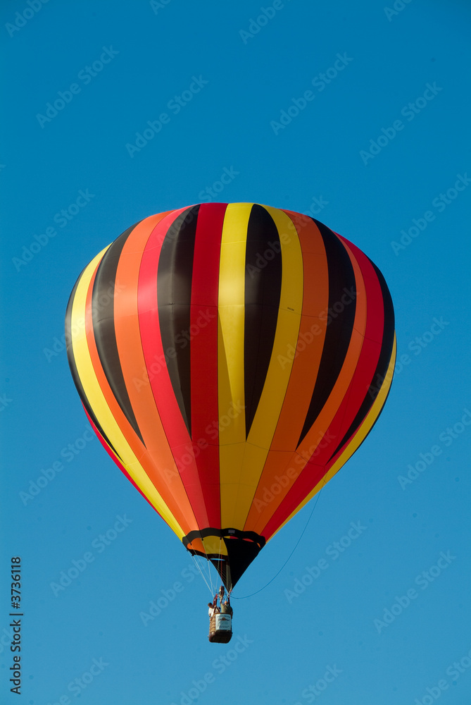 Colorful Hot Air Ballons in flight over clear blue vermont sky Colorful Hot Air Ballons in flight over clear blue vermont sky