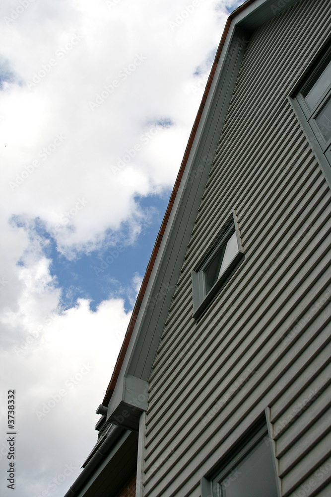 looking up at a white picket house