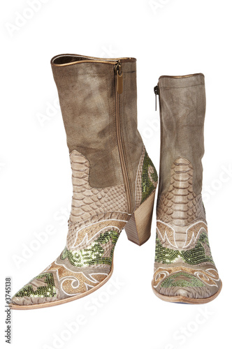 Cowboy's boots with an ornament on a white background