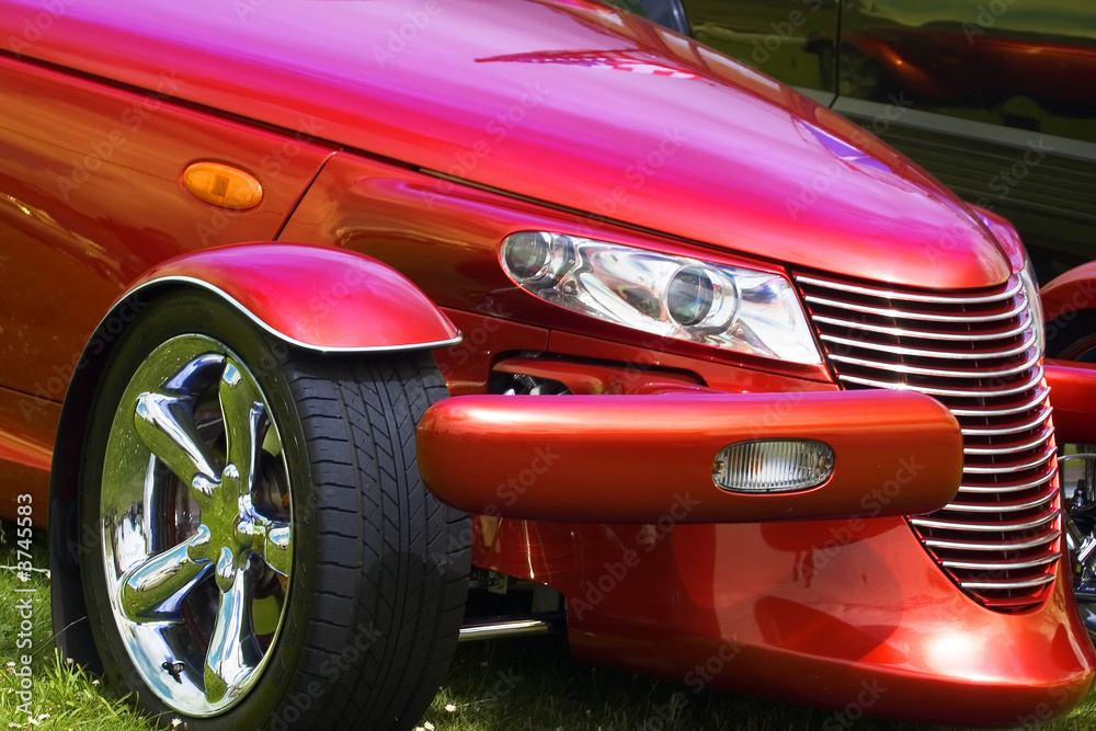A close up photograph of a brightly coloured hot rod car