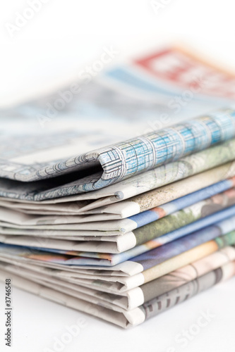 Stack of newspapers on white background