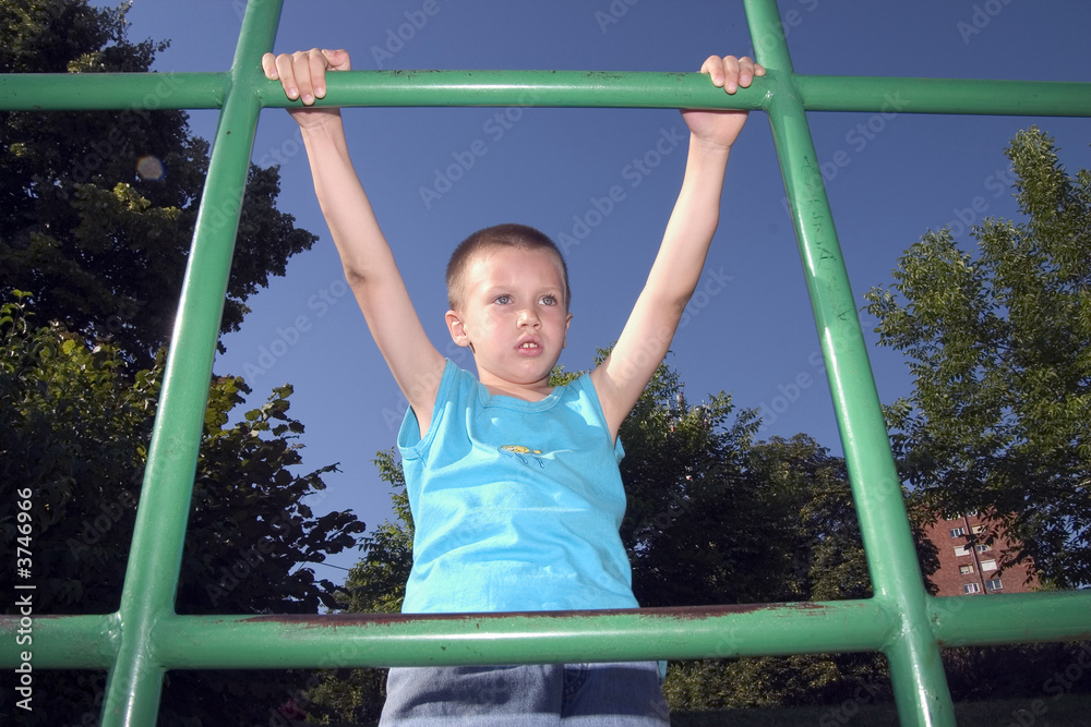 Fototapeta premium boy is climbing on the green pipes