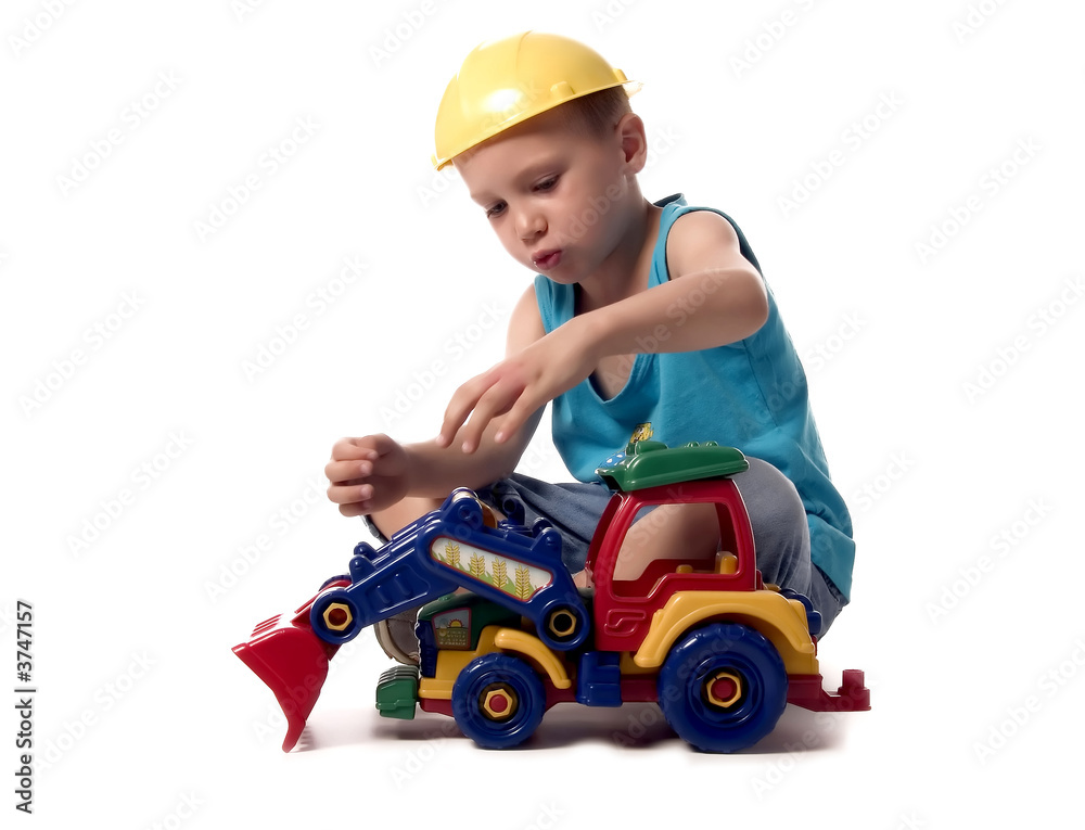 a boy is playing with his dredger a boy is playing with his dredger