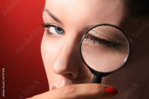 portrait of beauty cosmetic girl with magnifier