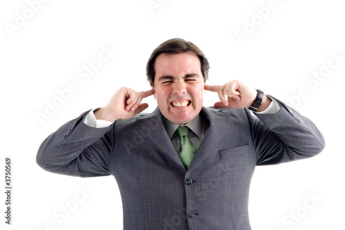 A businessman covering his ears with his fingers