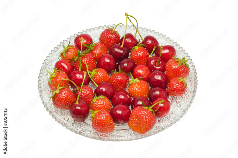 Strawberries and cherries on a glass dish, isolated on white Strawberries and cherries on a glass dish, isolated on white