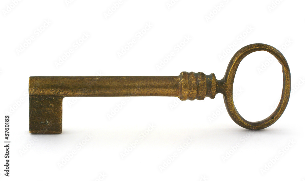 gilded antique key with a smalll shadow in front against white gilded antique key with a smalll shadow in front against white