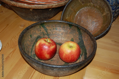 zwei Äpfel in einer alten Keramikschüssel photo