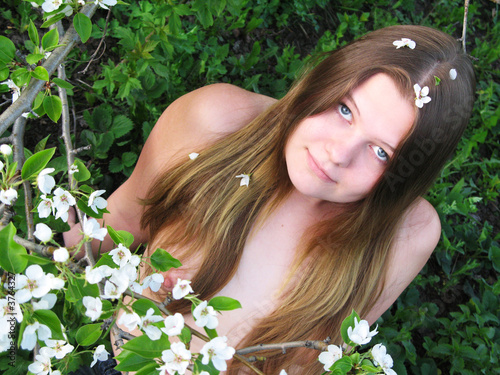 Pretty nude girl with flowers of apple.