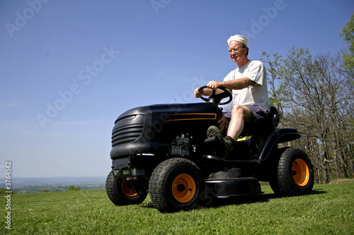 man sitting on a lawnmower