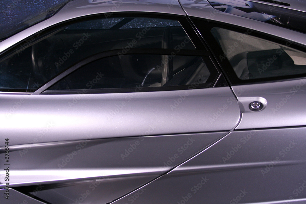 side of silver supercar