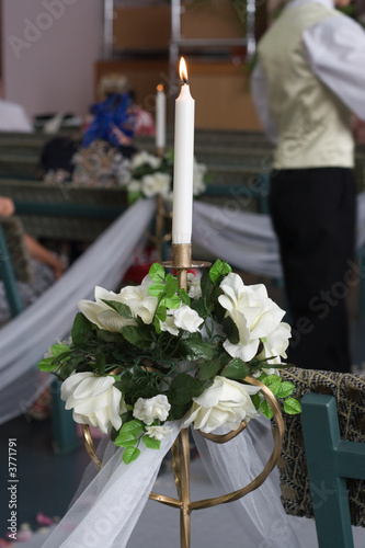 Wedding decorations-lit candle,flowers and tulle.Shallow depth