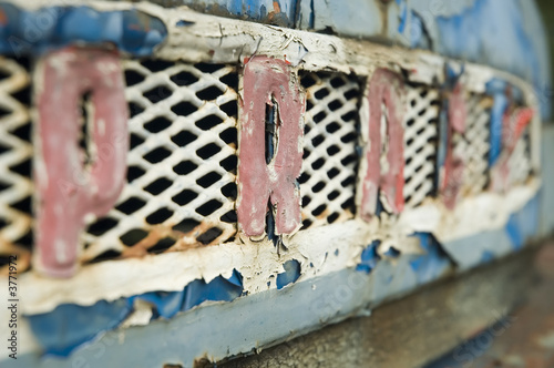 Blue old-fashioned rusty front mask of ancient car Praga V3S. photo