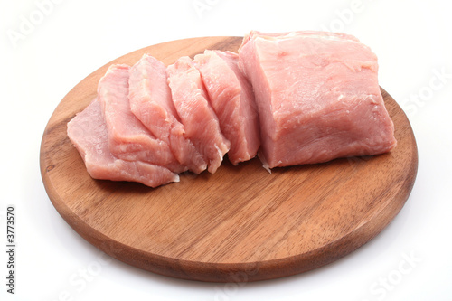 boneless pork loin on board - isolated on white