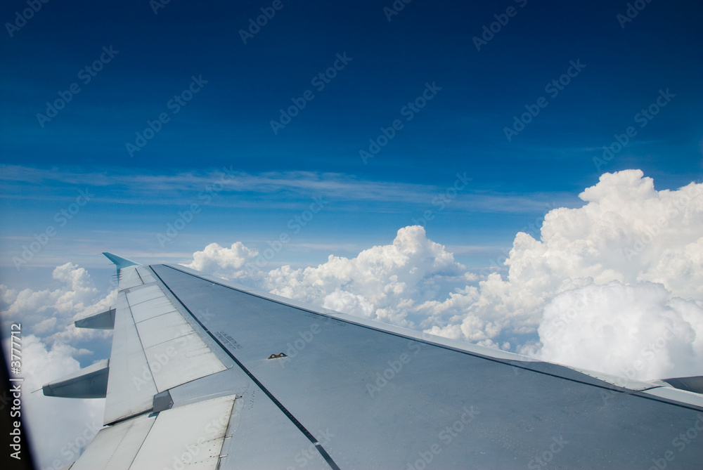 above the white clouds in a plane above the white clouds in a plane
