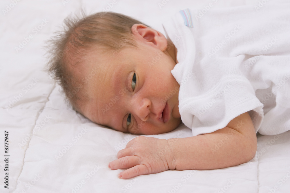 Cute little newborn baby looking around on white. Cute little newborn baby looking around on white.