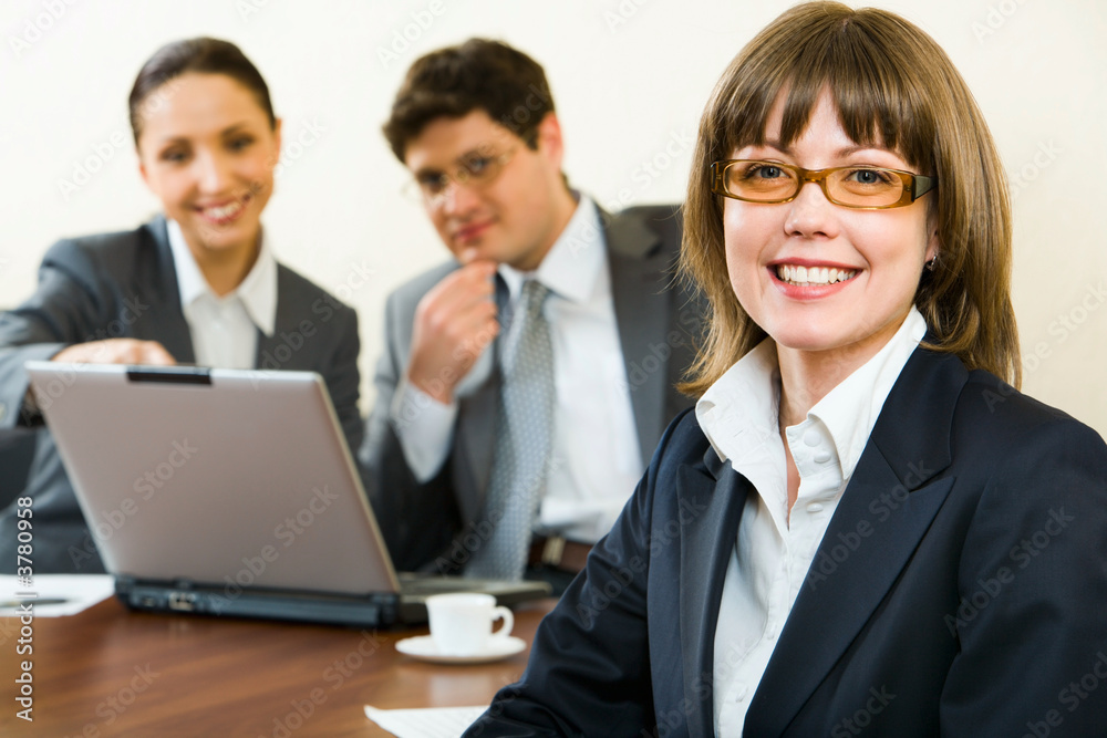 Smart woman on a background the colleagues in the office Smart woman on a background the colleagues in the office