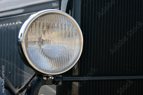 Headlight of black retro car close-up