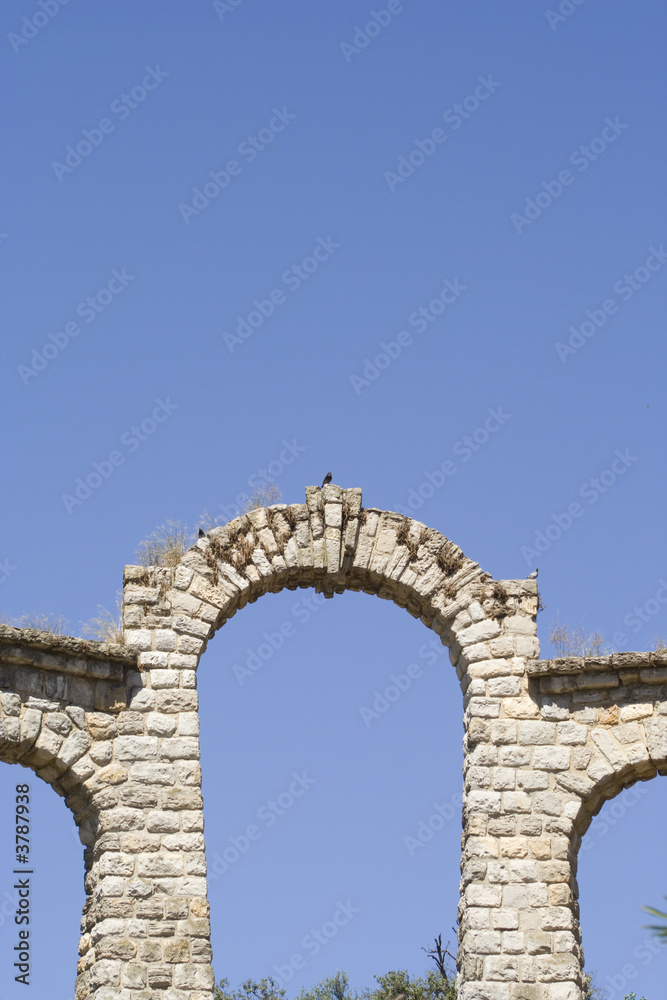 an old arch ruins with a blue sky