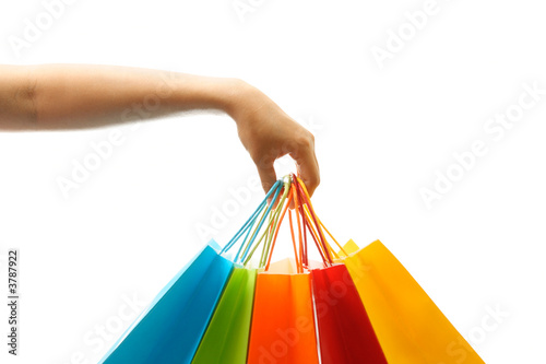 A woman hand carrying a bunch of shopping bags
