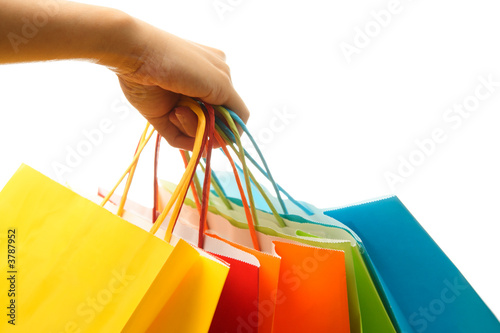 A woman hand carrying a bunch of colorful shopping bags #3787952