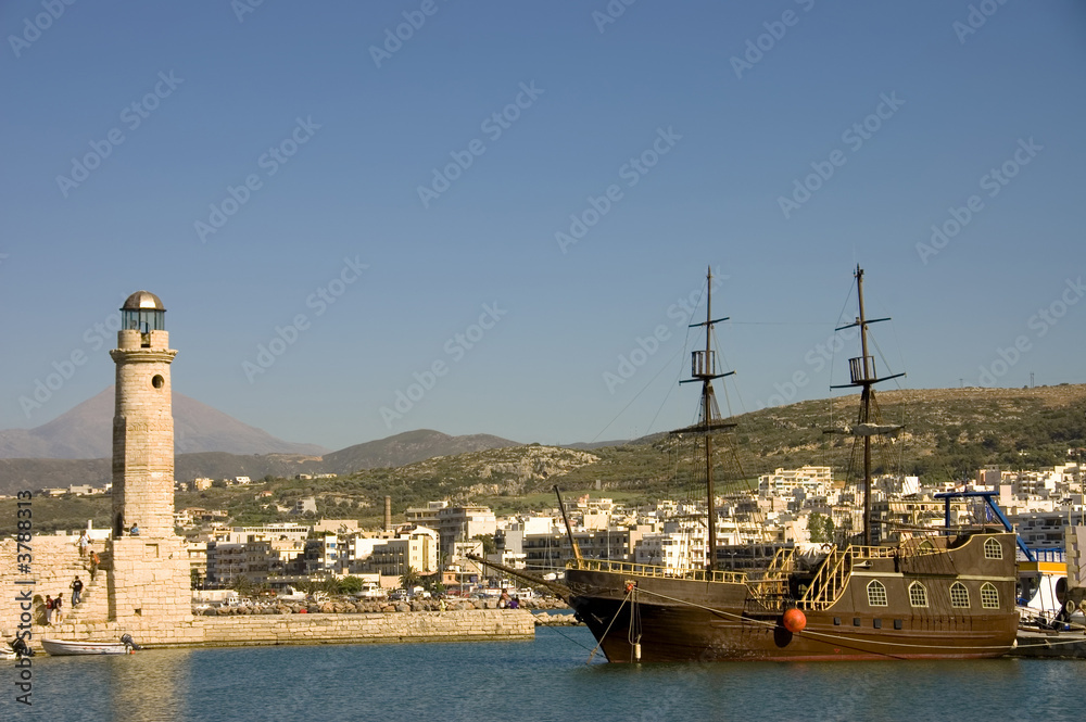 Fototapeta premium Chania harbor in Crete, Greece with lighthouse schooner