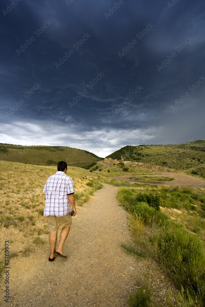 Hiker walking in to the storm