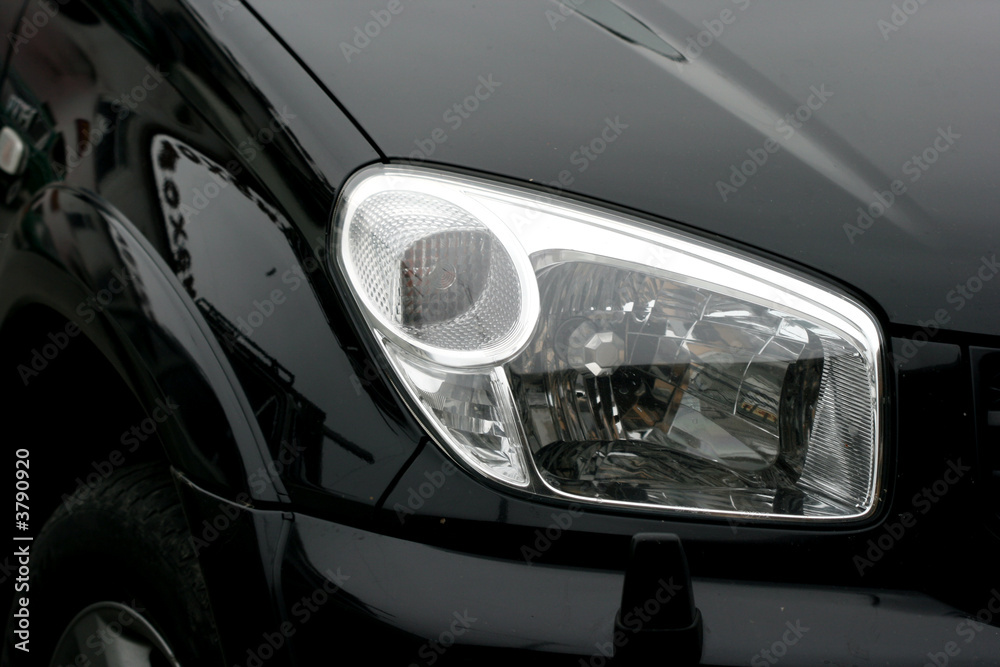 headlight of a  black luxury car