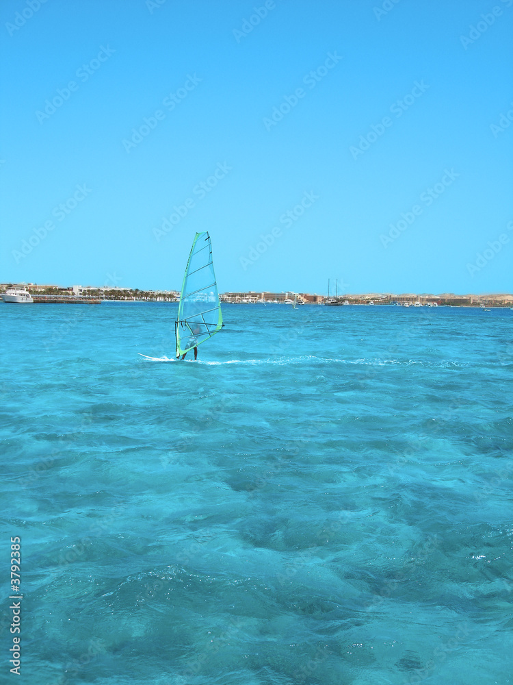 windsurfer in blue sea windsurfer in blue sea