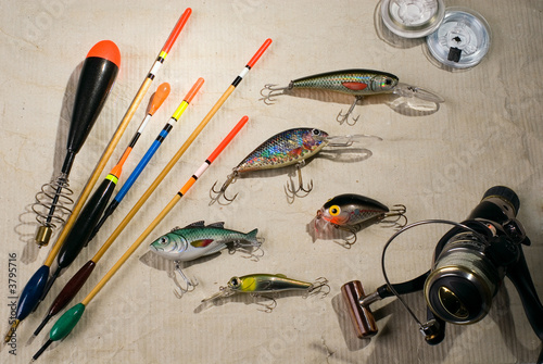 Multi-coloured fishing tackles are spread out on a table