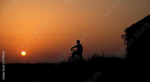 mountain biker silhouette in sunrise © Imre Forgo