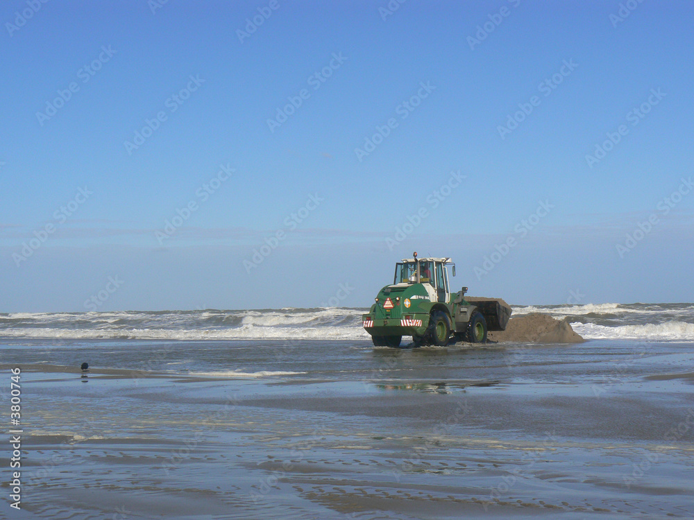 bulldozer smoothing out beach area 