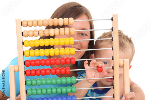 mother and 3-4 years old boy with big abacus isolated on white