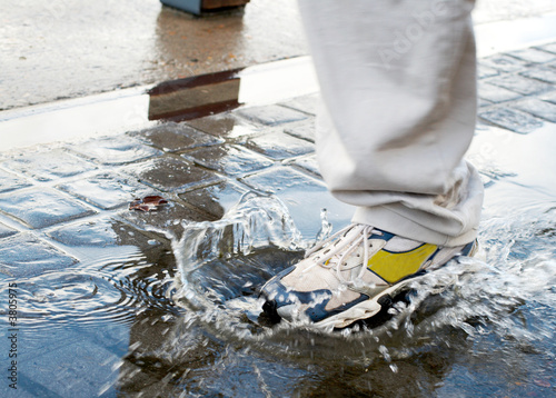 Man stepping into a pool of water in a rush 