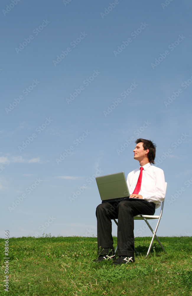 Man sitting outdoors using laptop Man sitting outdoors using laptop