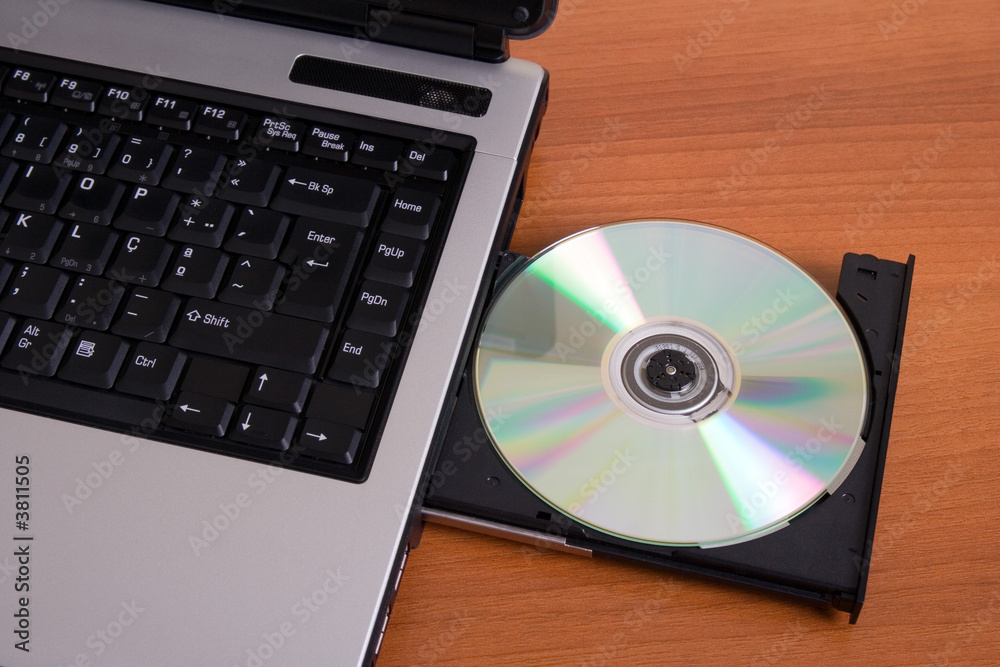 Partial top view of a laptop with the dvd recorder opened Partial top view of a laptop with the dvd recorder opened