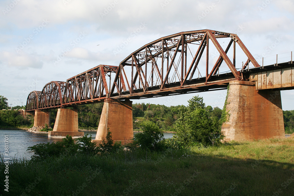 A rusty old train tressel spanning the river